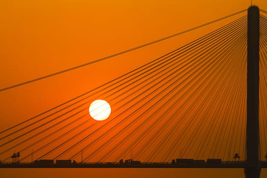 Silhouette of a bridge under setting sun