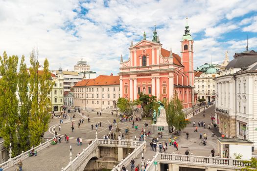 Romantic Ljubljana's city center: river Ljubljanica, Triple Bridge, Tromostovje, Preseren square and Franciscan Church of the Annunciation. Ljubljana, Slovenia, Europe.