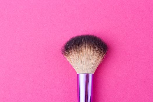 Set of makeup brushes on pink background. Top view point, flat lay.