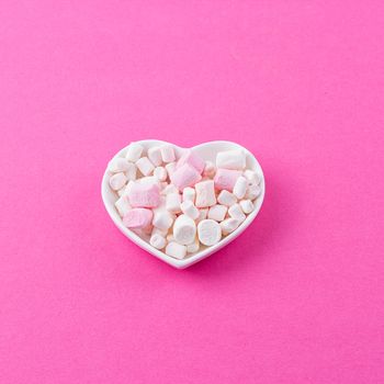 red heart-shaped plate with marshmallows, space for text, congratulations on Valentine's Day, top view
