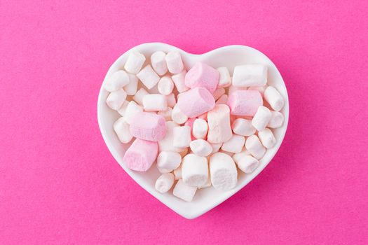 red heart-shaped plate with marshmallows, space for text, congratulations on Valentine's Day, top view