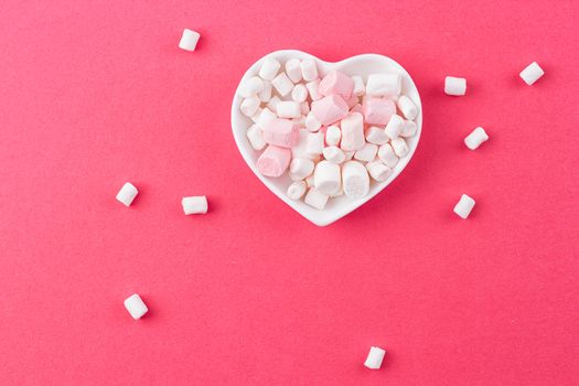 red heart-shaped plate with marshmallows, space for text, congratulations on Valentine's Day, top view