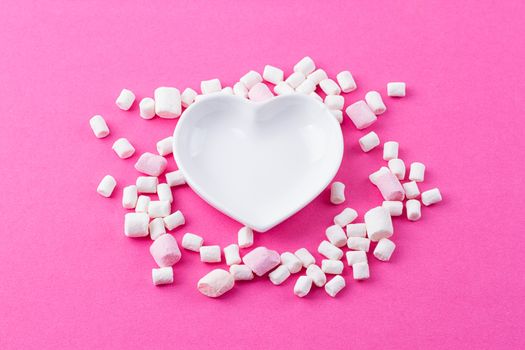 red heart-shaped plate with marshmallows, space for text, congratulations on Valentine's Day, top view