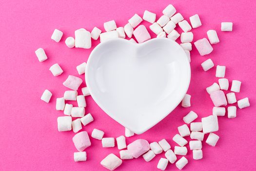 red heart-shaped plate with marshmallows, space for text, congratulations on Valentine's Day, top view