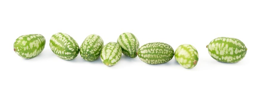 Row of eight cucamelons, Mexican sour gherkin, pepquino, or mouse melon, isolated on a white background