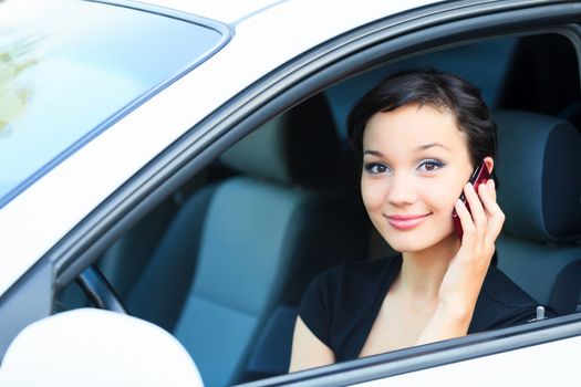 Woman driver using a mobile telephone