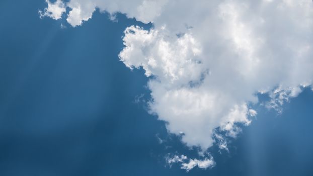 White fluffy clouds on a blue sky background