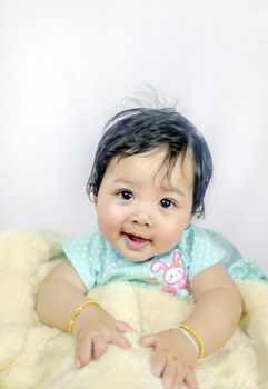 Asian Smiling baby girl crawling in bedroom