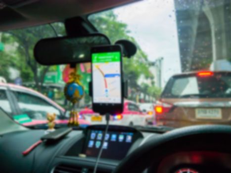 Blurred,Use smart phone on magnet car mount phone holder Gps