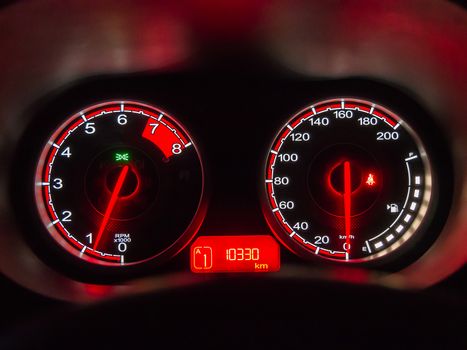 A close up of the front instrument panel or dashboard of a modern automobile.