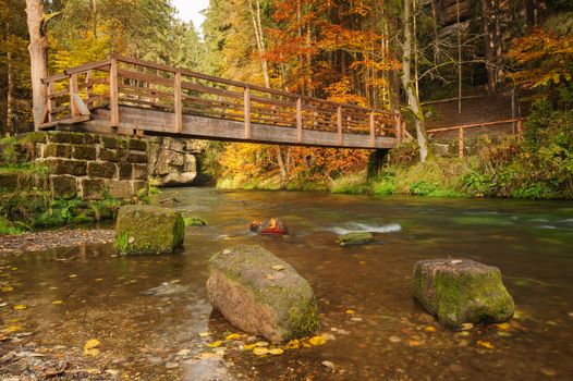 Autumn colored trees, leaves, rocks around the beautiful river