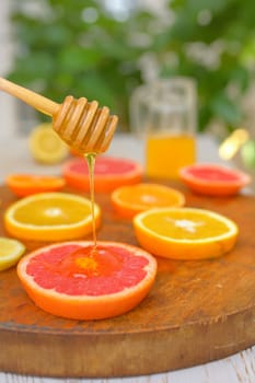 Slices of grapefruit, clementine, orange and honey