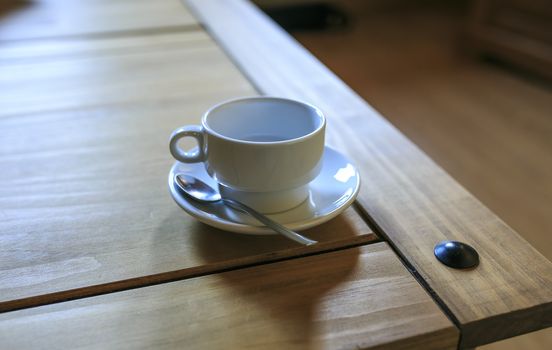 white Cofee cup in a wooden table