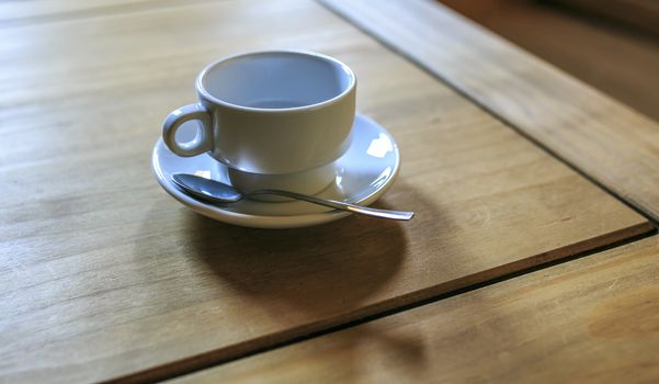 white Cofee cup in a wooden table