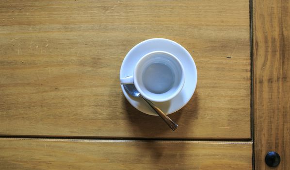 white Cofee cup in a wooden table