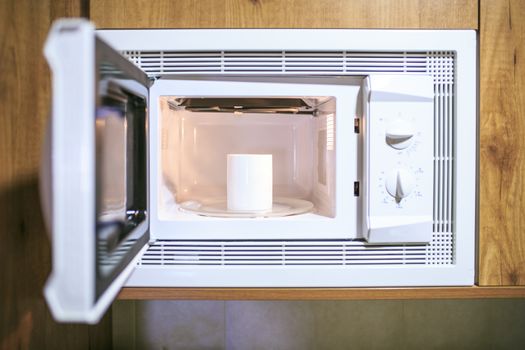 Cup of coffee in a microwave