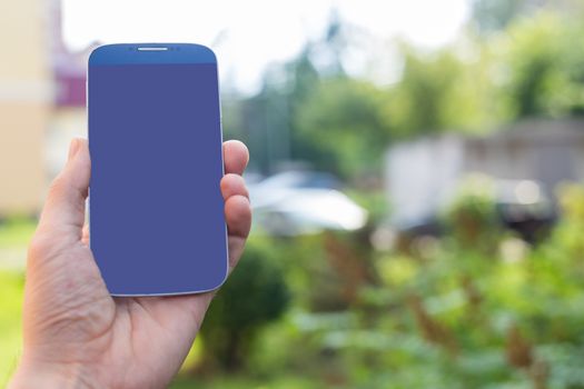 Man using his Mobile blank screen outdoor, close up