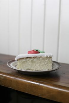 Single slice of white cake with buttercream icing