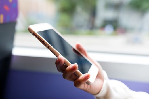 Woman use of mobile phone inside bus of Hong Kong