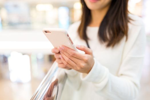 Woman sending sms on cellphone