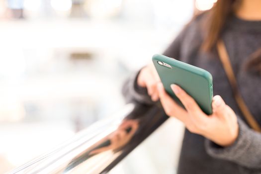 Woman sending sms on mobile phone