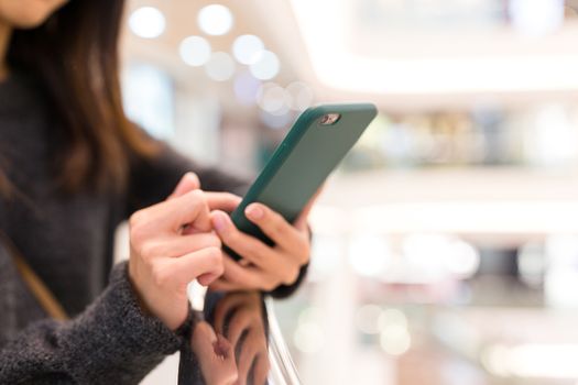 Woman use of mobile phone in shopping mall