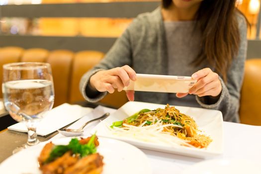 Woman taking photo on her dinner