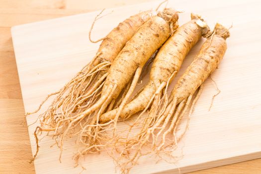 Ginseng over wood background