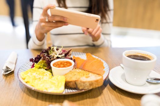 Woman taking photo on her meal