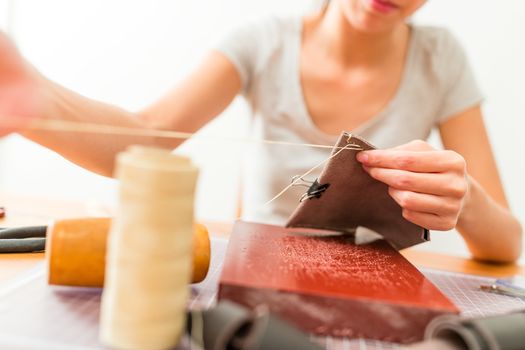 Leather craftsman making a bag