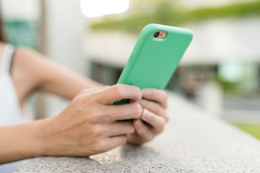 Woman using mobile phone in the street