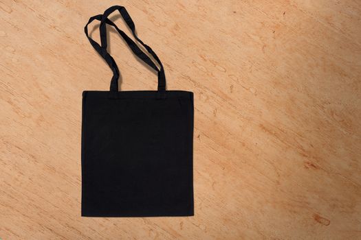 black cotton bag for shopping on a wooden background