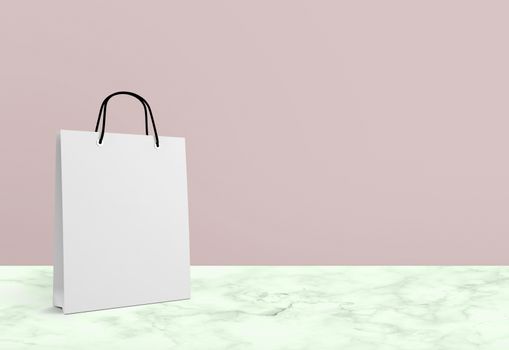 white paper bag for shopping on a pink background