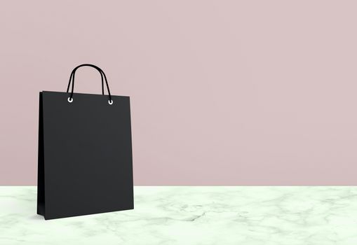 black paper bag for shopping on a pink background