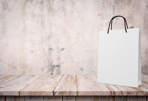 white paper bag for shopping on a wooden background