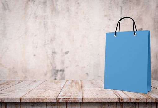 blue paper bag for shopping on a wooden background