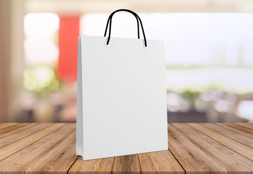 white paper bag for shopping on a wooden background