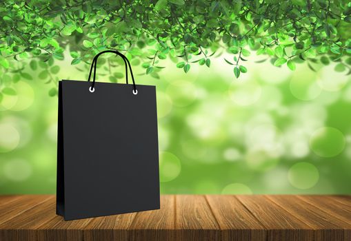 black paper bag for shopping on a wooden background