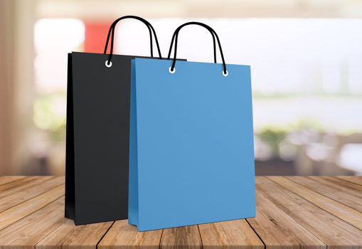 Two paper bags for shopping on a wooden background