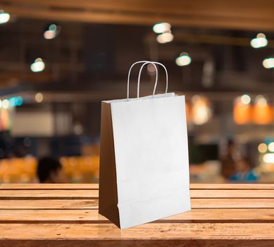 light paper bag for shopping on a wooden background