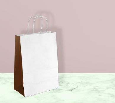 light paper bag for shopping on a pink background