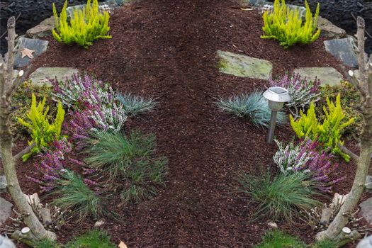 Small freshly made flowerbed in front of a house.