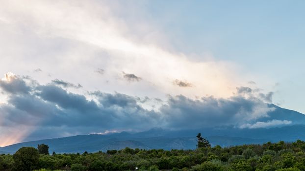 View of volcano Etna from a small Sicilian village at sunset