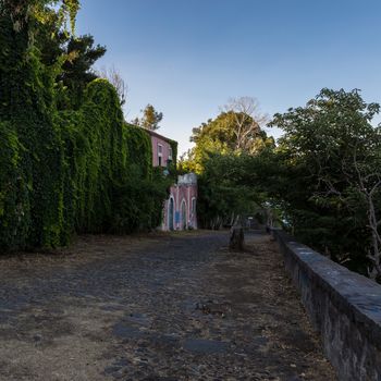 Country road in Sicily with ancient colonial house