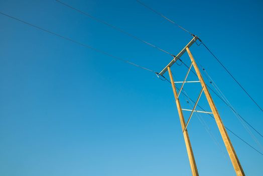 Electricity post and a blue sky background.