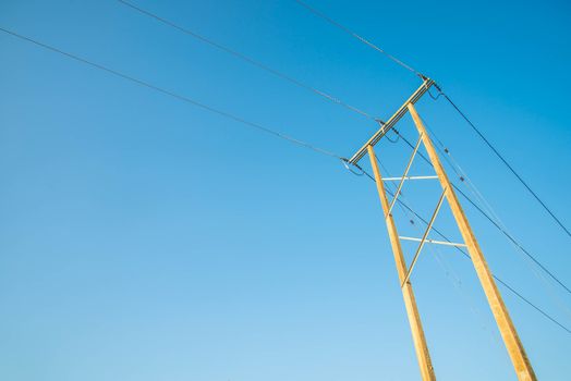 Electricity post and a blue sky background.