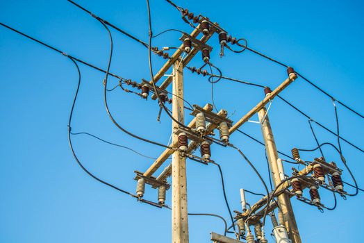 Electricity post and a blue sky background.