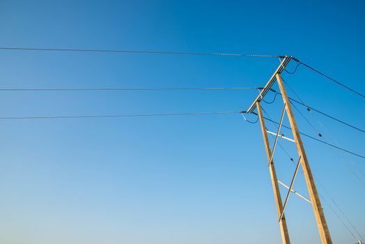 Electricity post and a blue sky background.