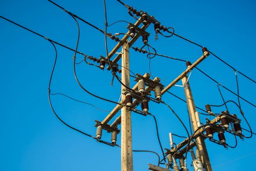 Electricity post and a blue sky background.