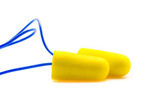 Yellow earplugs with blue band on white background.